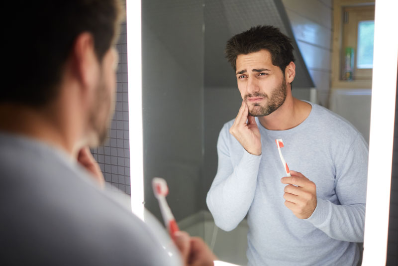 Dental Implant Patient Suffering From Gum Disease, Otherwise Known As Peri-Implantitis