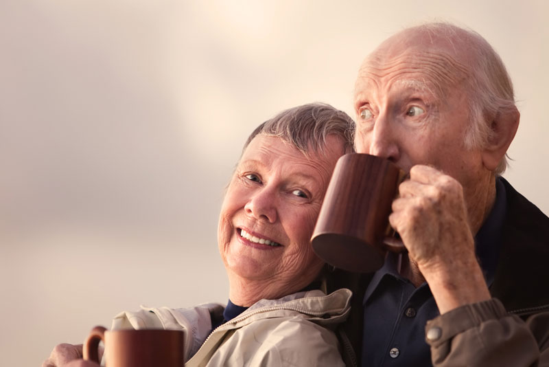 Two Dental Implant Patients Smiling While Drinking Coffee